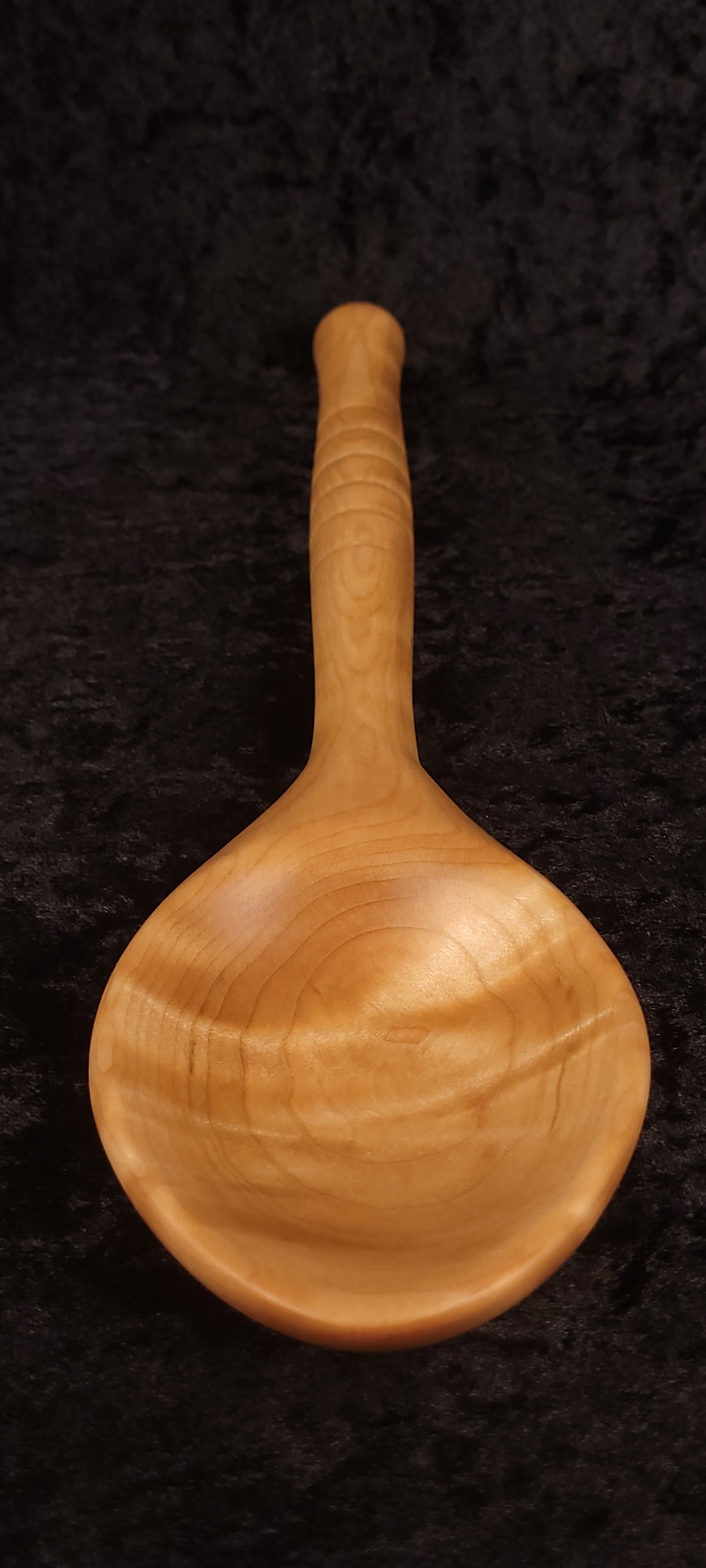 Curly maple spoon front view, alternate angle showing bowl depth
