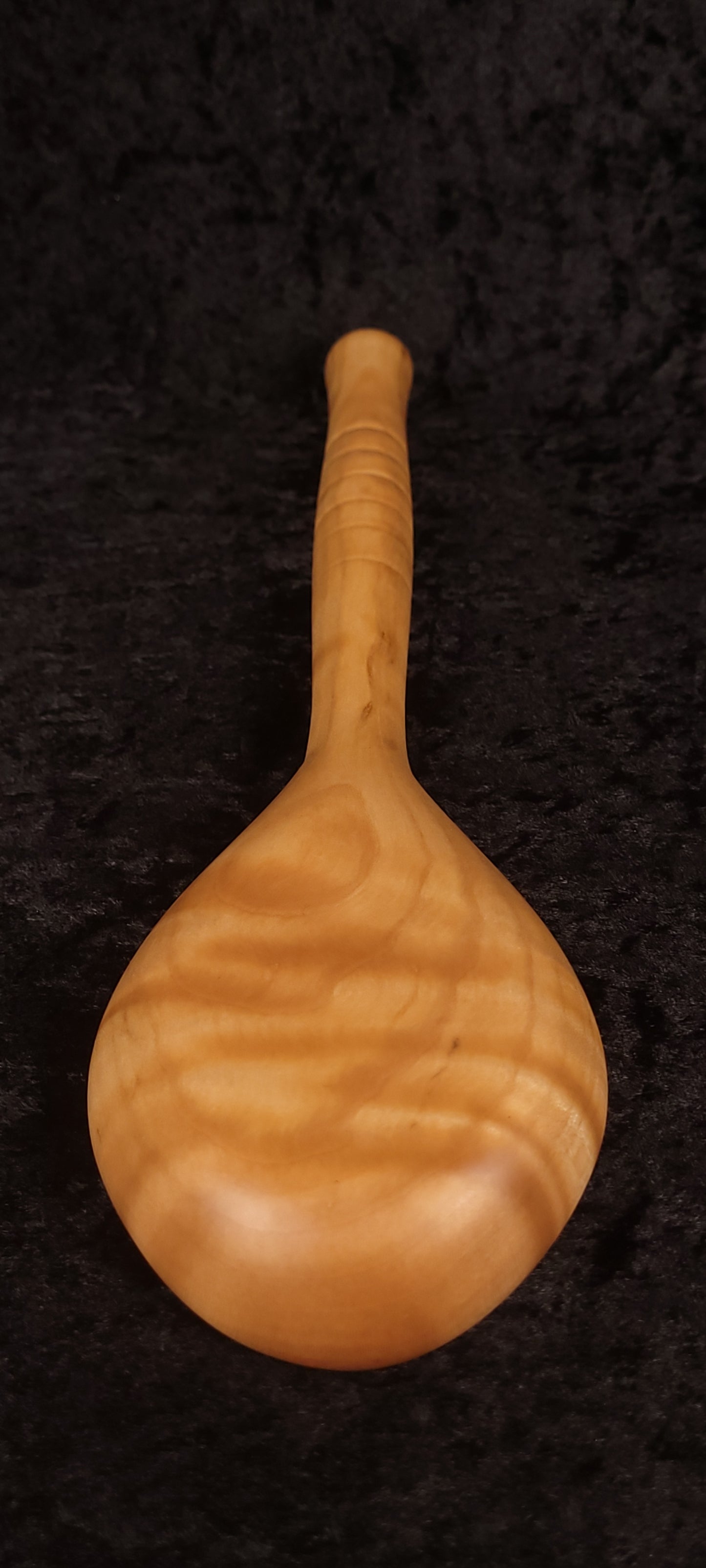 Curly maple spoon top-down view showing bowl and handle