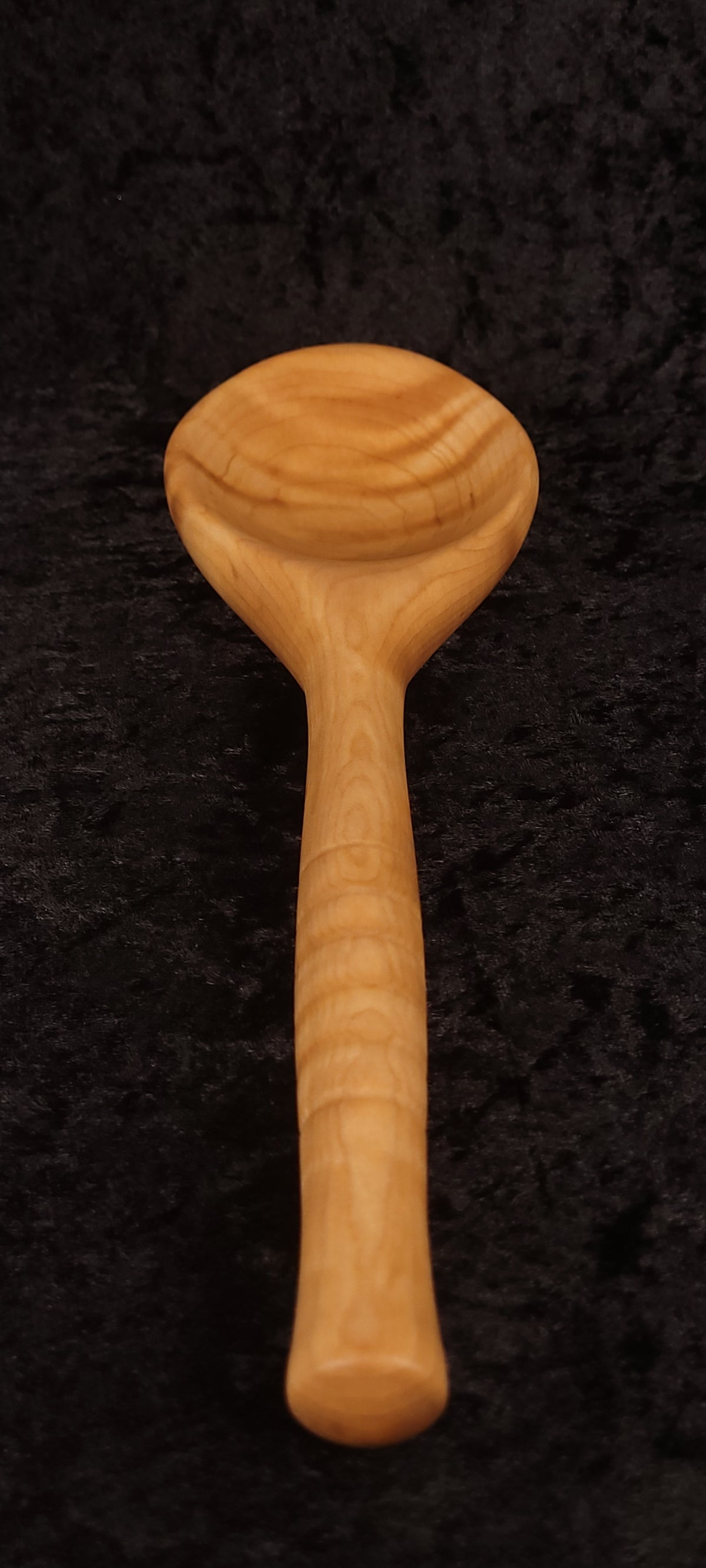 Curly maple spoon top-down view, alternate angle