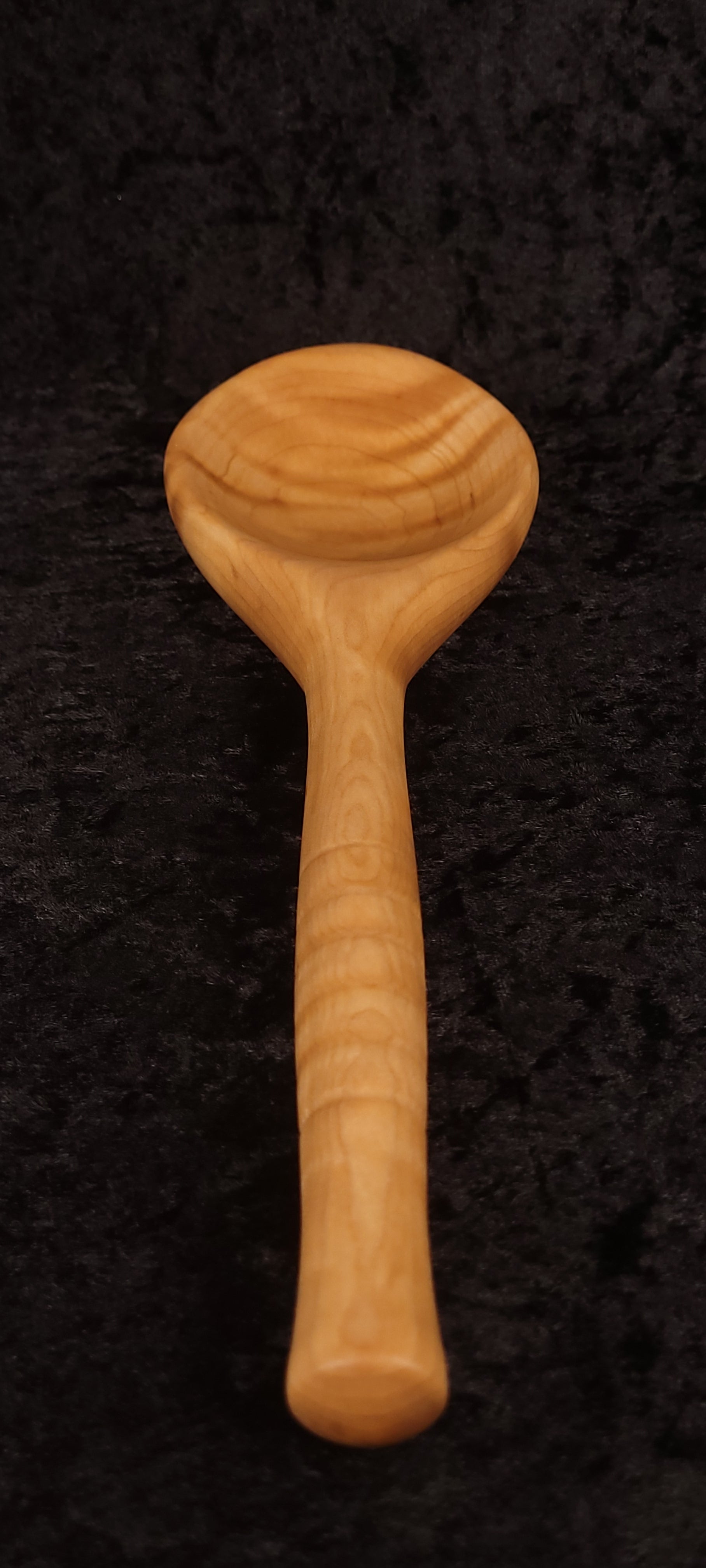 Curly maple spoon top-down view, alternate angle