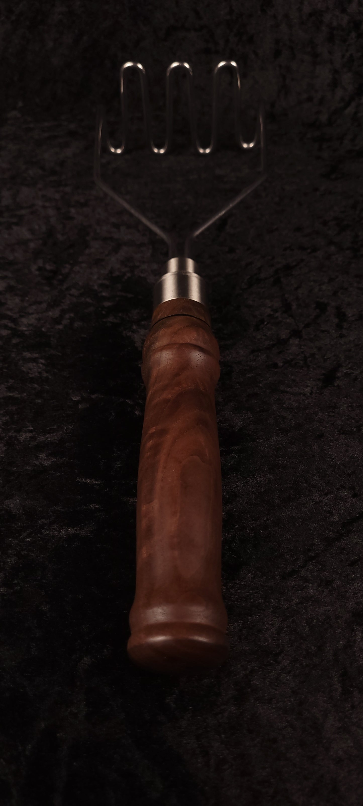 Close-up of walnut handle and silver ferrule connection