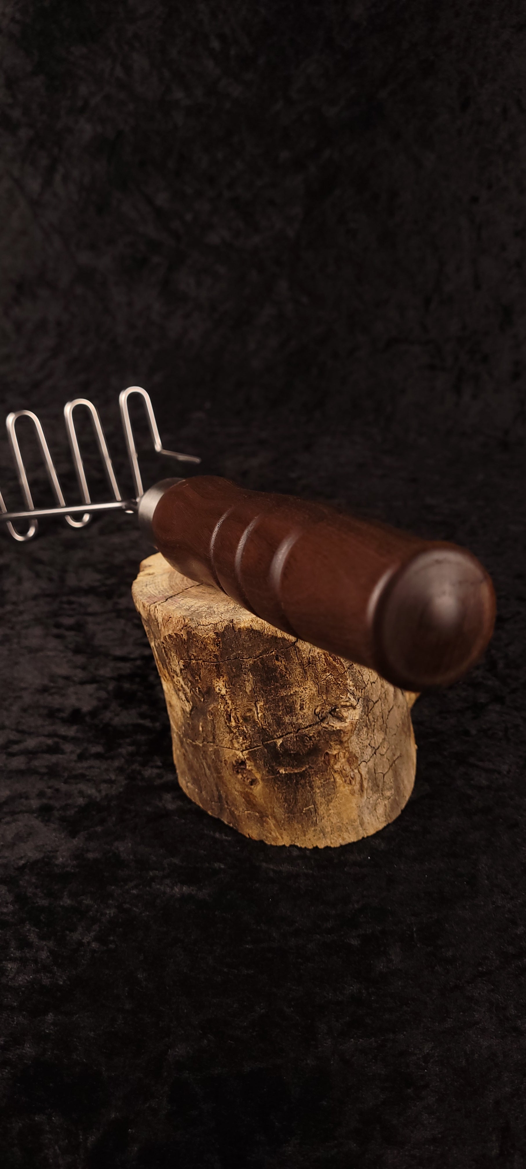 Walnut potato masher handle ball end detail on wood round