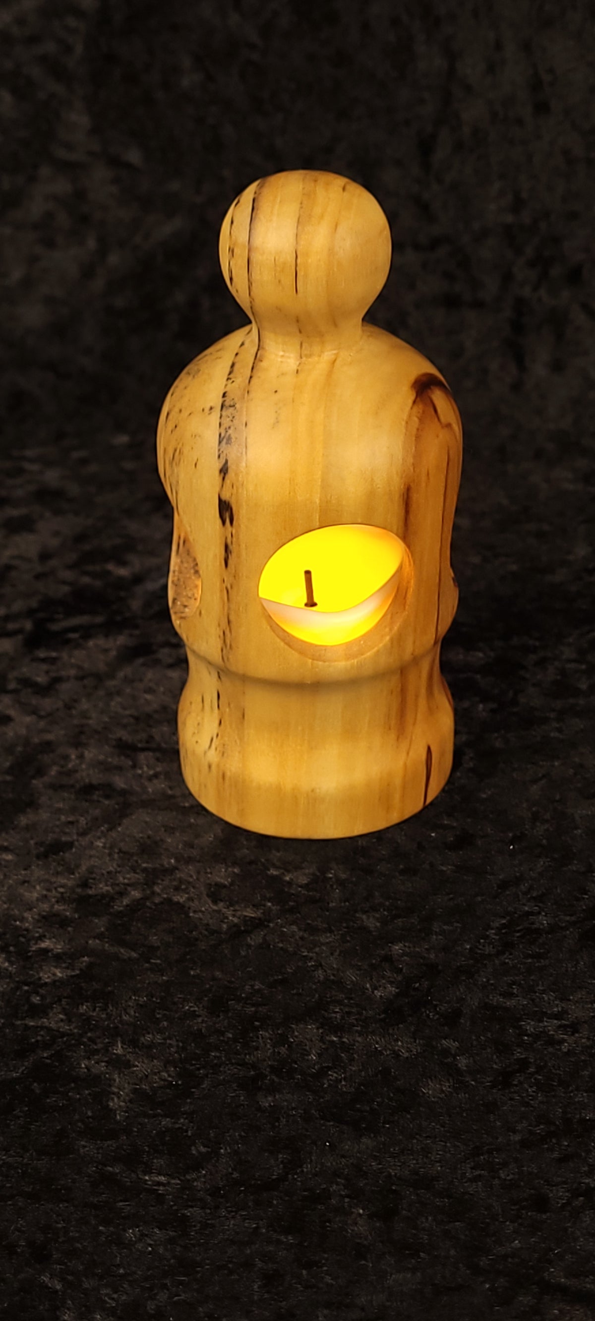 Cottonwood lantern tipped on side showing hollow interior and LED tea light votive