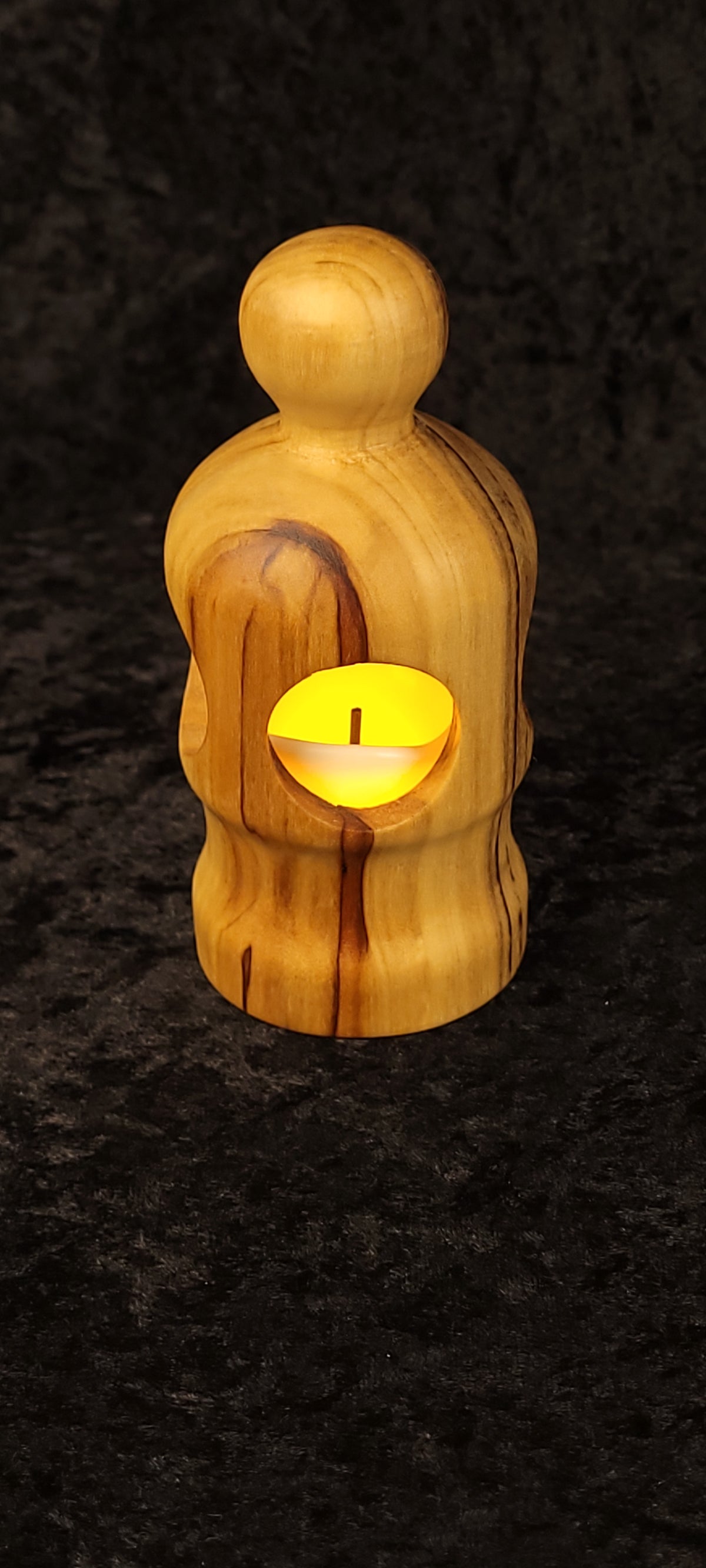 Hand holding cottonwood figurative lantern showing scale - LED glowing through oval openings
