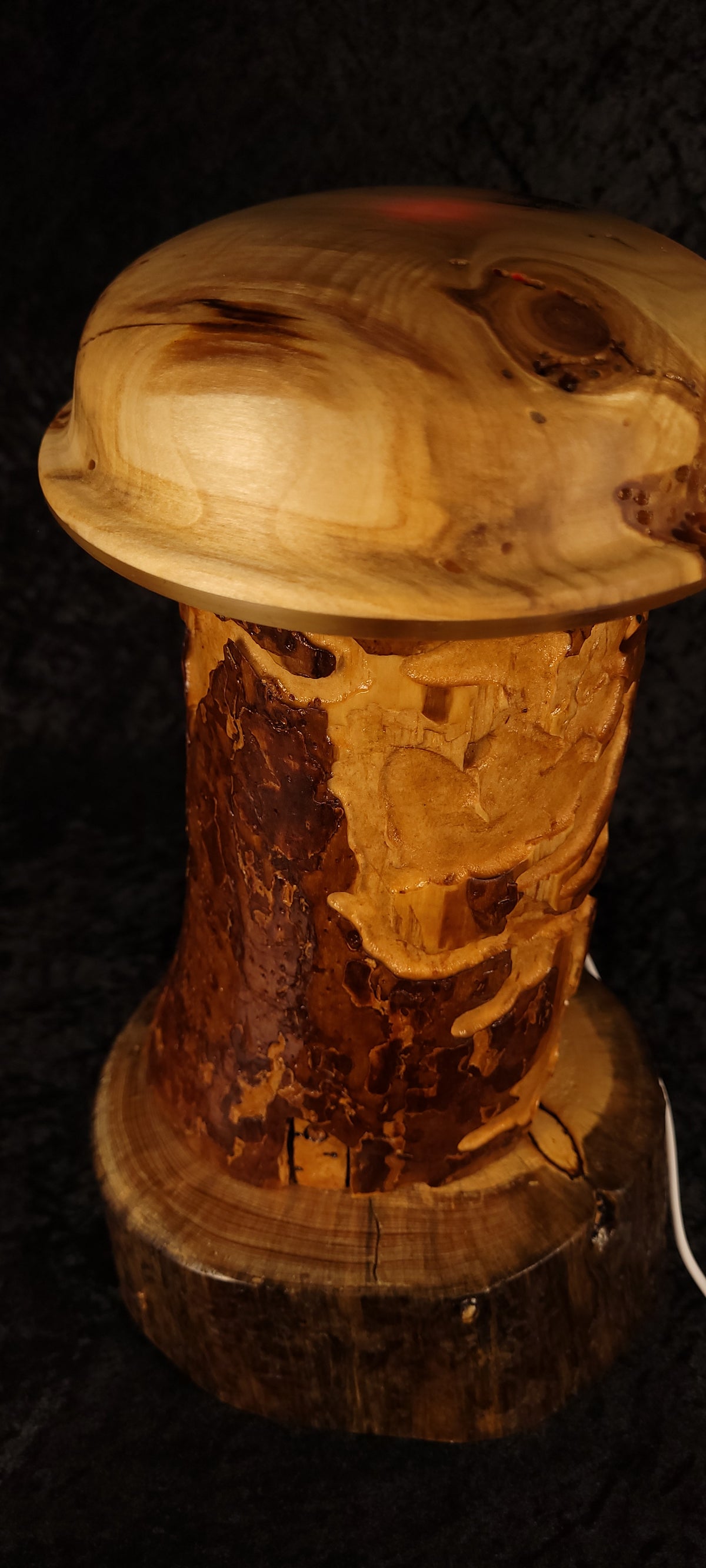 Handcrafted Wormy Pine RGB Lamp lit with red RGB glow, angled view