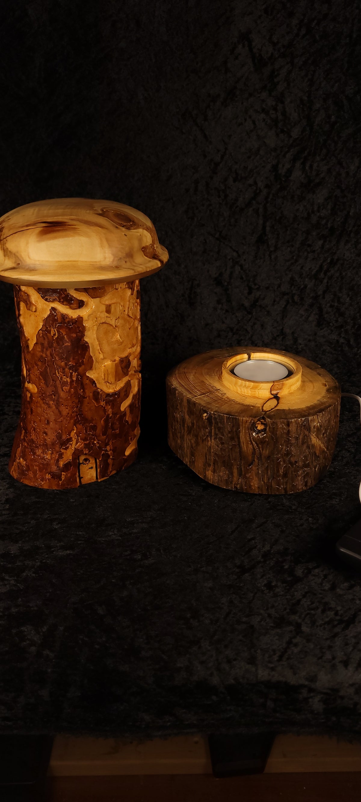 Wormy Pine RGB Lamp beside Piñon candle holder, both lit — scale reference
