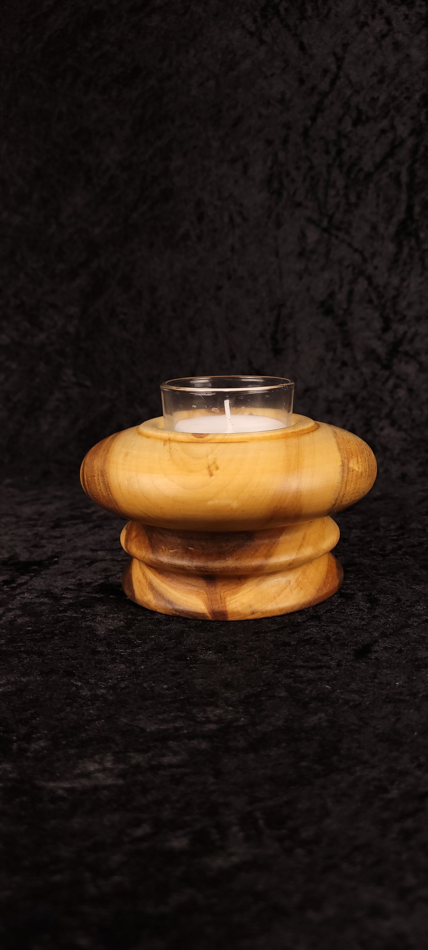 Underside of handcrafted Aspen wood candle holder showing Wet Mountain Woodcraft mark