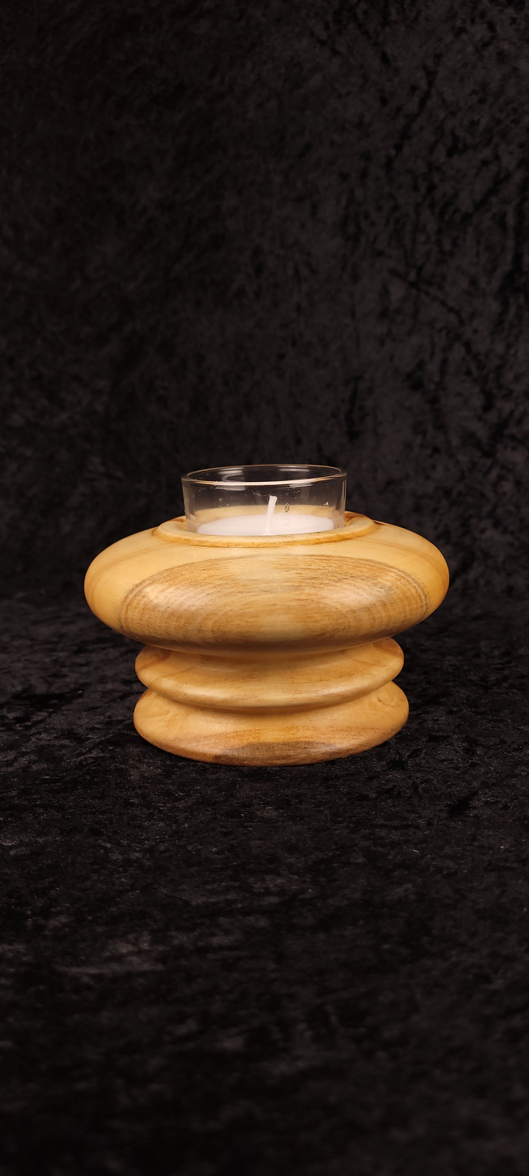 Handcrafted Aspen wood candle holder with glass votive insert, angled view