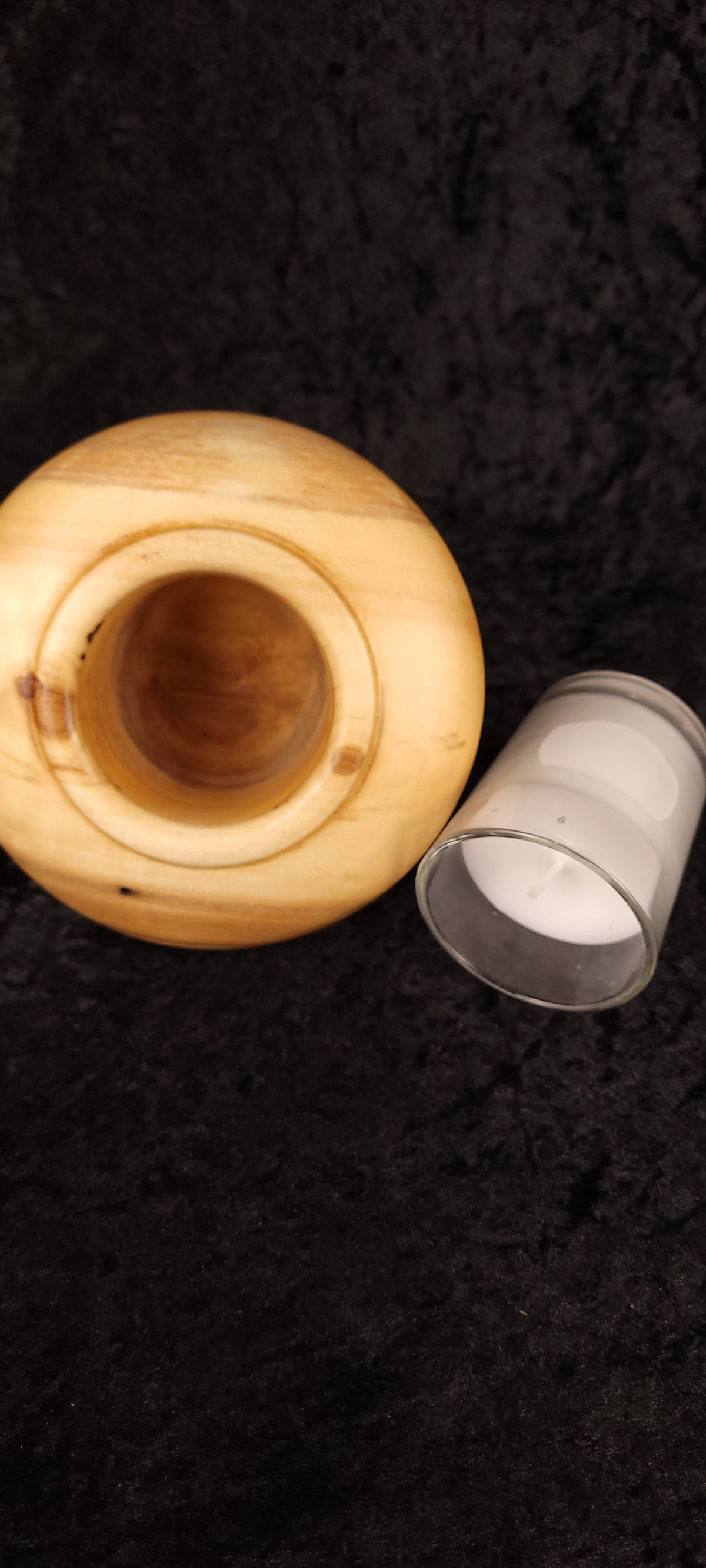 Close-up of glass votive candle insert in handcrafted Aspen wood holder